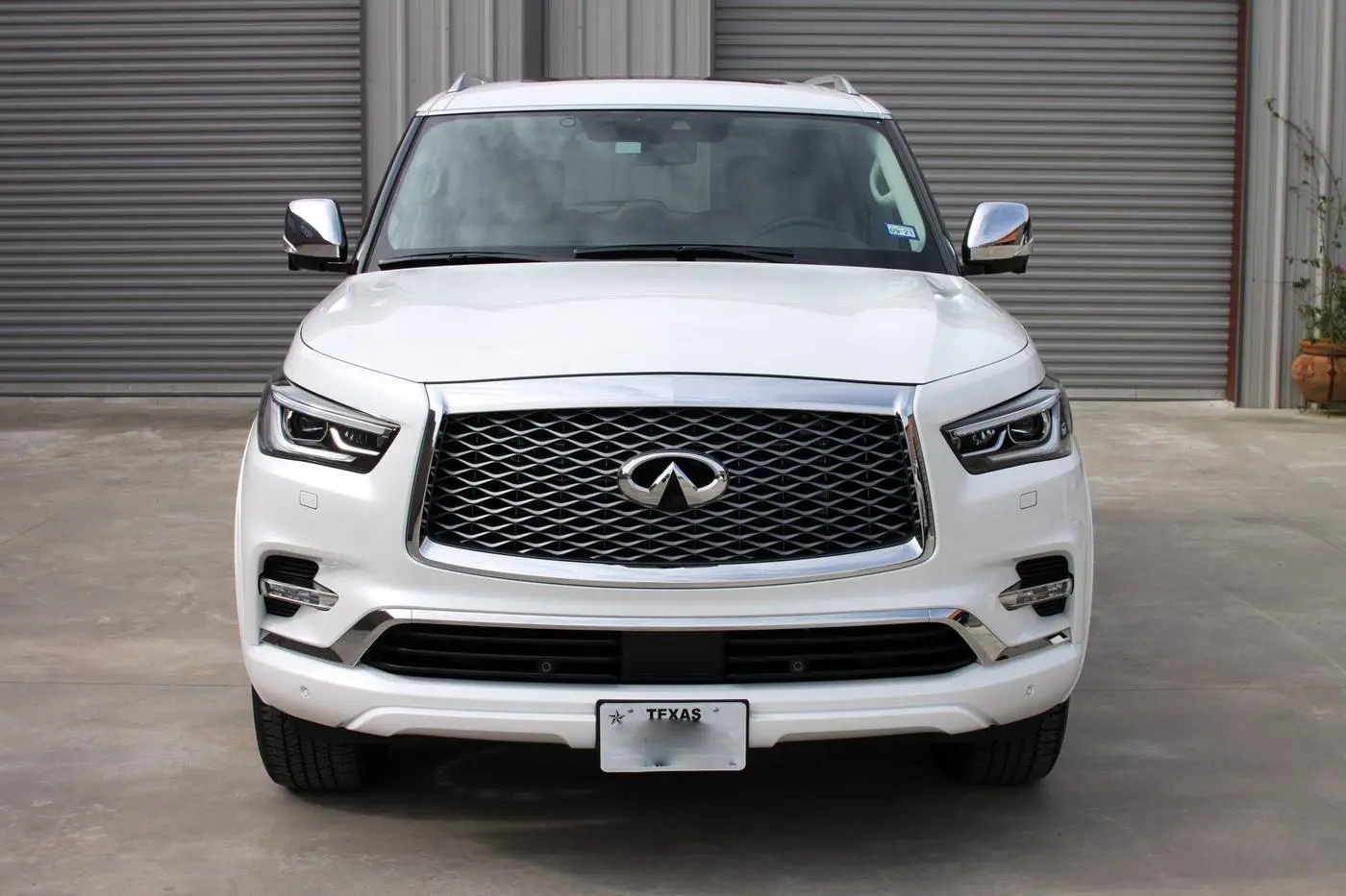 White Infiniti QX80 detailed by Derrick's Details in Austin, photo 1 of 18
